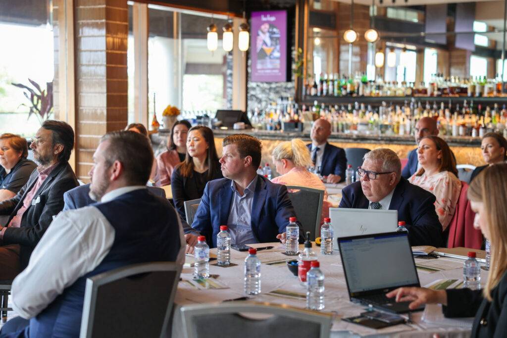 People sitting at tables during a conference
