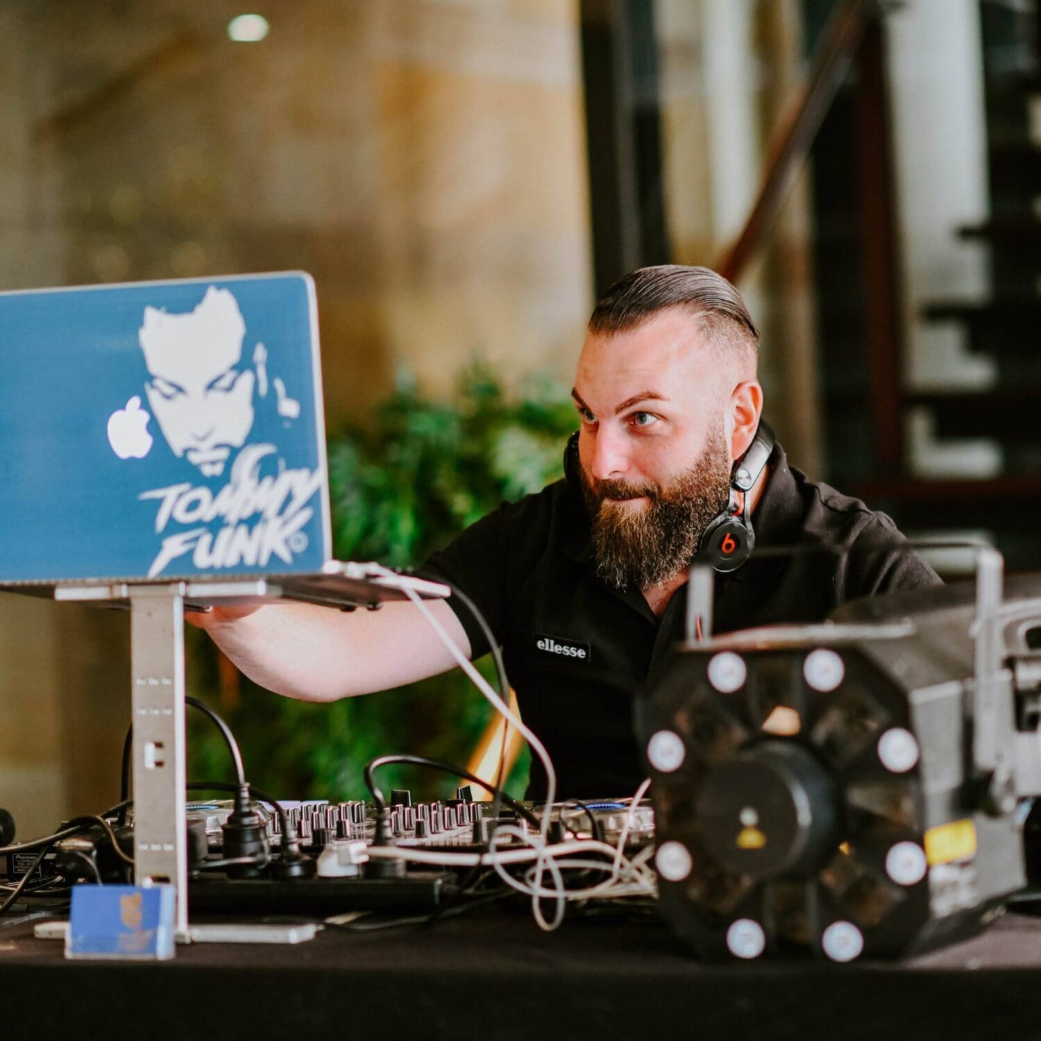 DJ looking at his DJ deck, playing music at private function