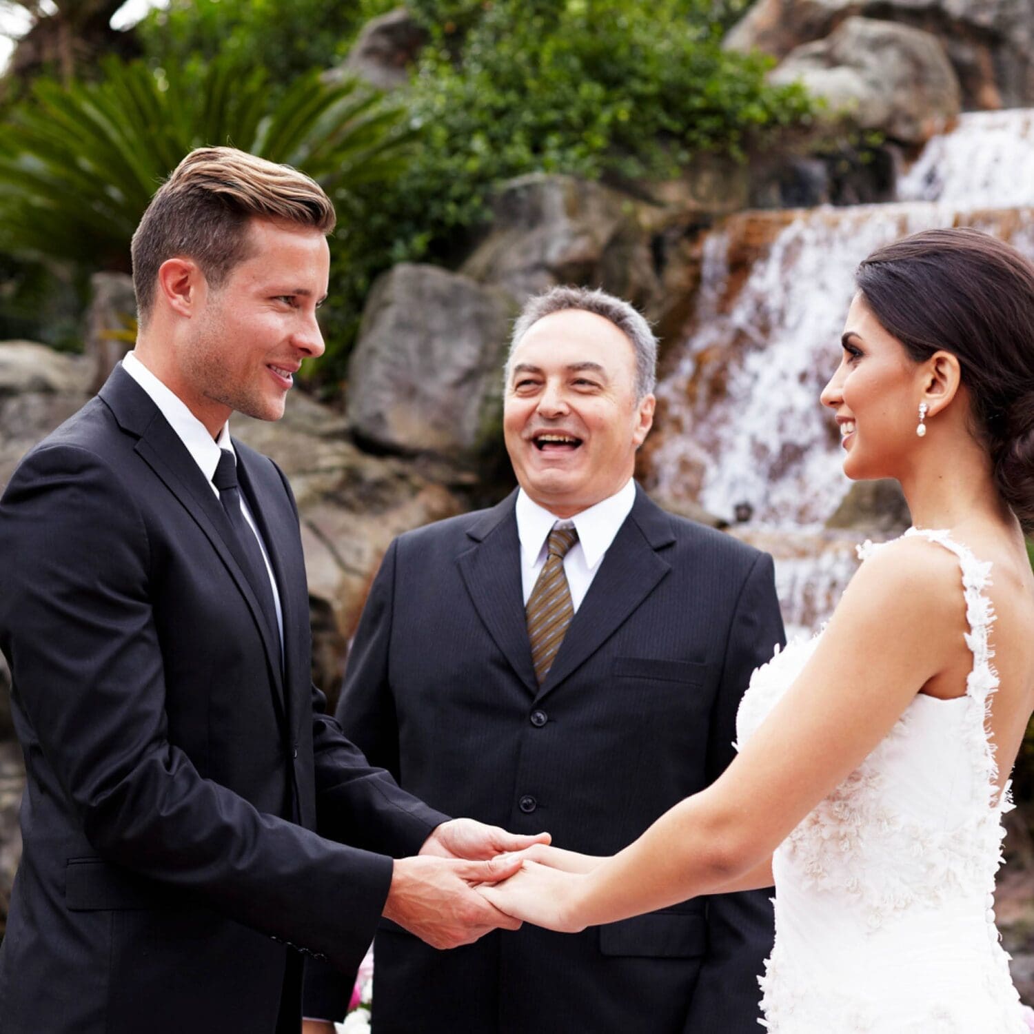 Happy wedding couple at the aisle with celebrant